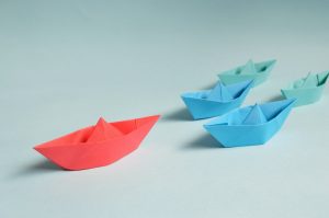 Red, blue and green paper boats