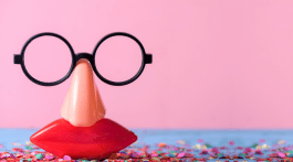 A set of plastic glasses, nose and mouth with a pink background