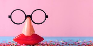 A set of plastic glasses, nose and mouth with a pink background