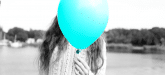 bright balloon covering a persons face