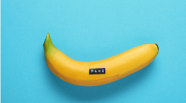 fake banana with a label maker label that reads "fake"