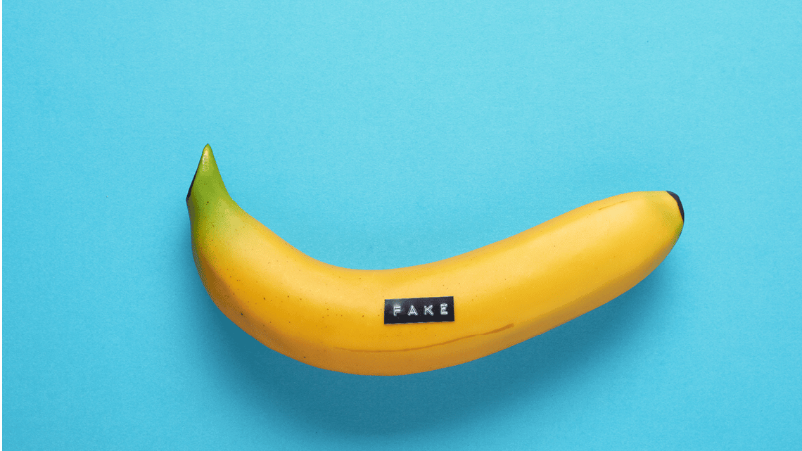 fake banana with a label maker label that reads "fake"