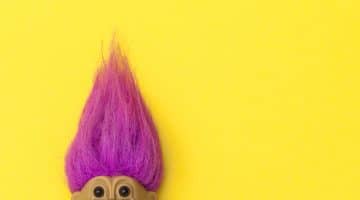 troll with pink hair on yellow background