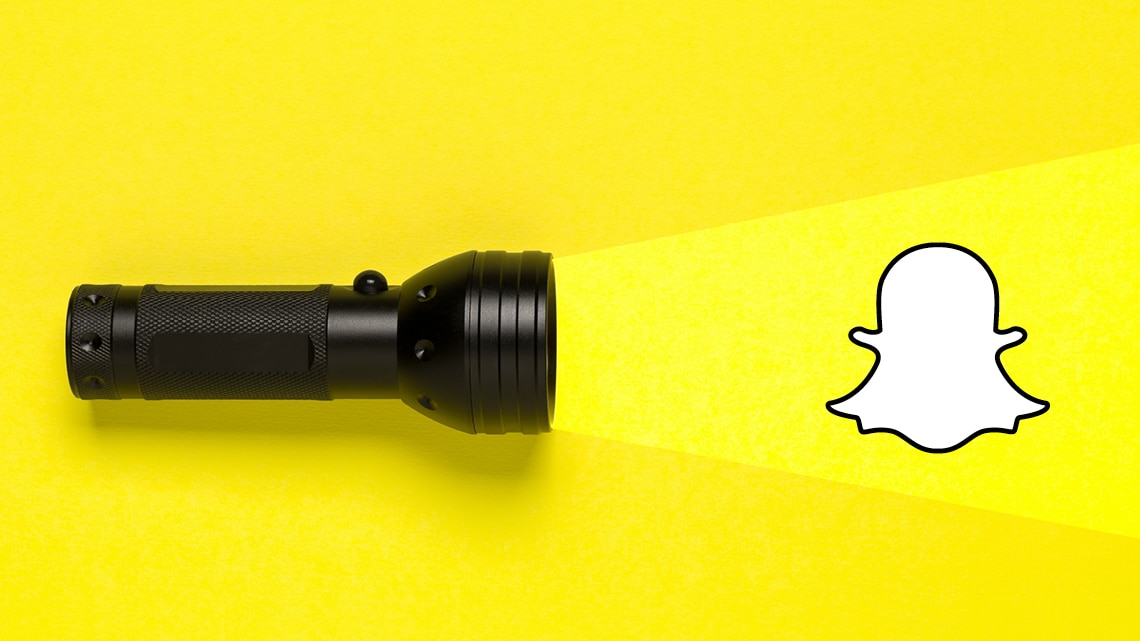 flashlight on yellow background pointing light to snapchat logo