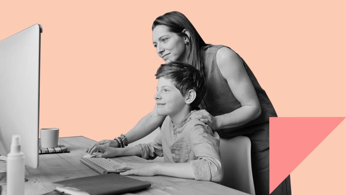 mother helping teenage son with desktop