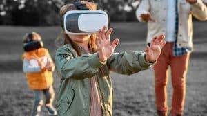 A child walking with a virtual reality device on their head