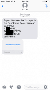 A screenshot of a text message received from an unknown number, claiming that a prize draw was won, asking the person to click a link