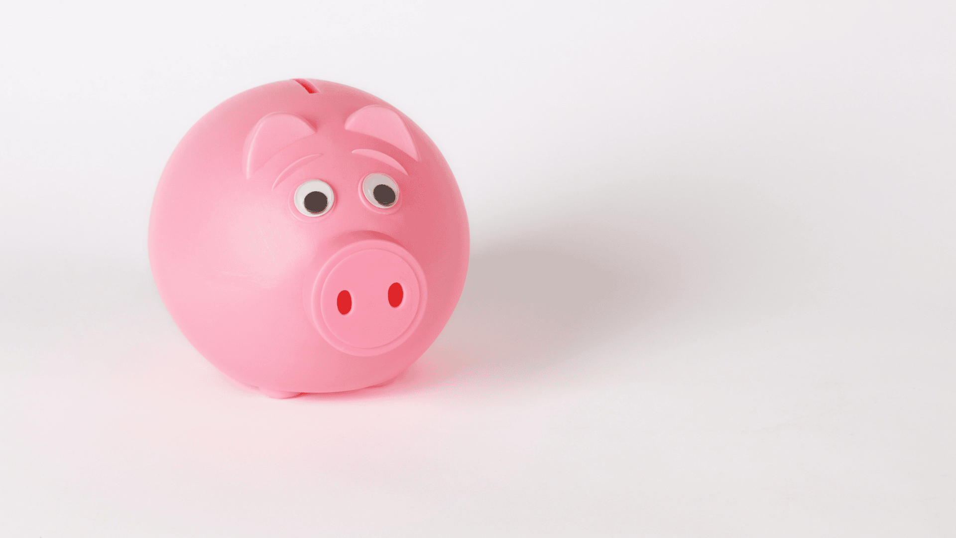 Image of a pink piggy bank sitting on a white background