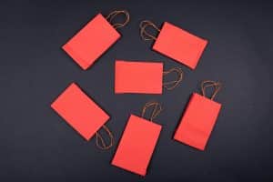 Multiple red flat shopping bags on a black background
